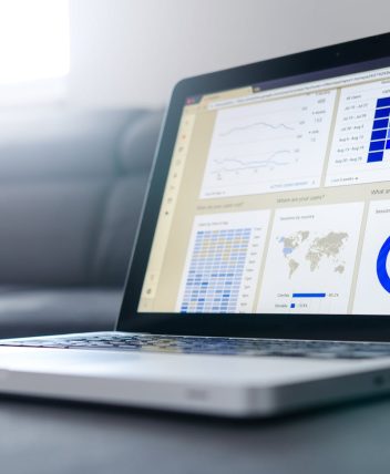Sleek laptop showcasing data analytics and graphs on the screen in a bright room.
